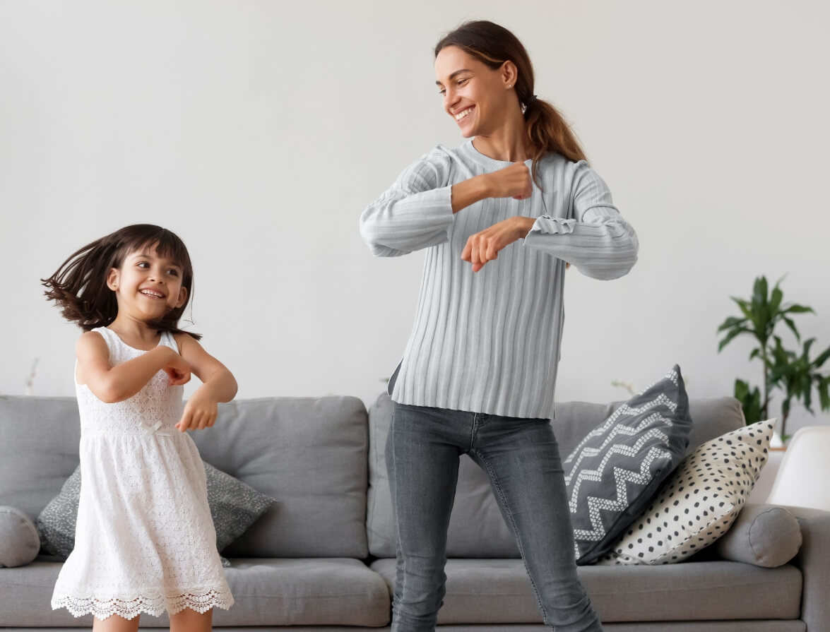 Mère et sa fille dansant dans leur salon